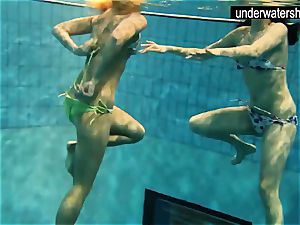 two luxurious amateurs showcasing their figures off under water